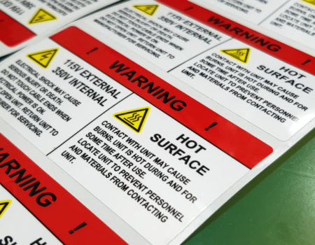 etiquette produit chimique Danger sign banner with warning text,"HOT SURFACE" warning label in electronic industry